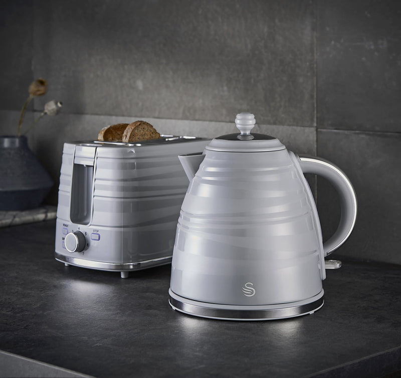 Grey Swan Symphony 1.7 Litre Jug Kettle and Symphony 2 Slice Toaster on a black kitchen counter against a grey tile background