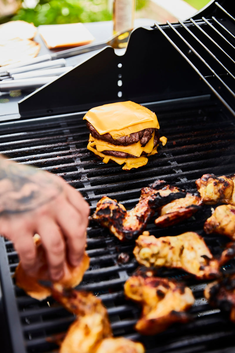 Close-up of burgers and cheese being grilled on the Swan Kansas BBQ