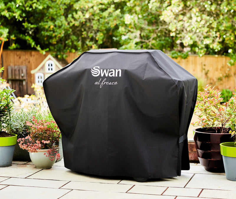 Swan BBQ Cover for SBQ57030N on a cream garden patio next to potted plants covering the Swan Kansas 3 Burner Gas BBQ with Side Burner 