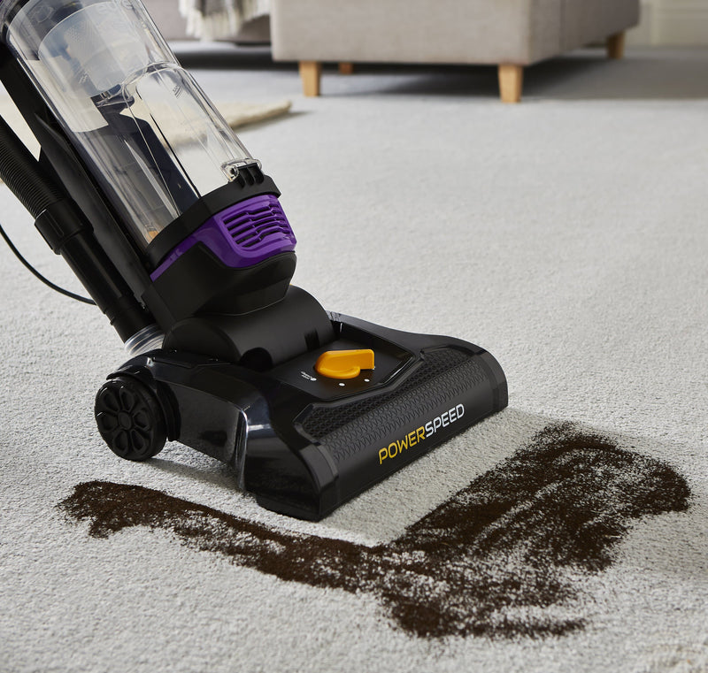 Close up of the Swan Powerspeed Upright Pet Extend Vacuum vacuuming dirt of a cream carpet