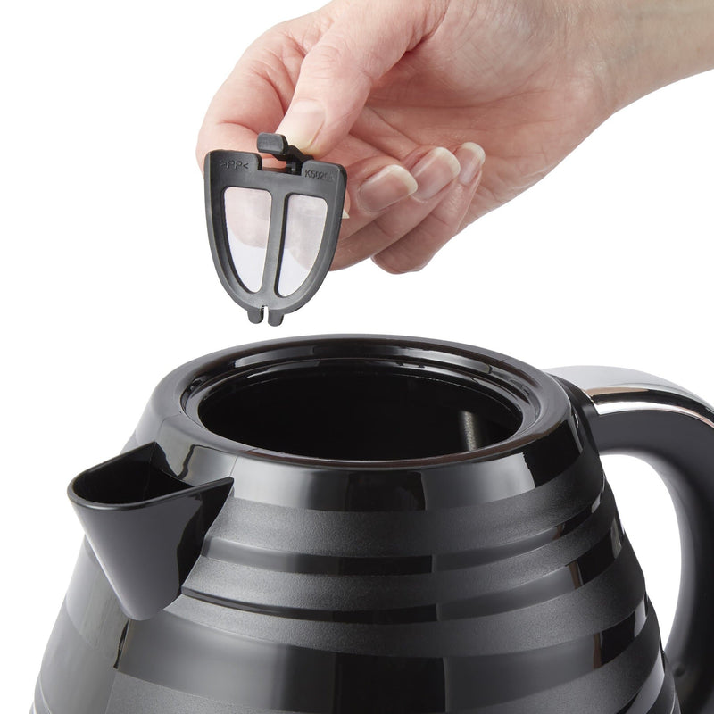 Close up of woman's hand removing the black Swan Symphony 1.7 Litre Jug Kettle against a white background