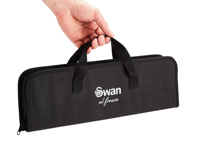 Man's hand holding the Swan BBQ Tool Set in black Swan bag.
