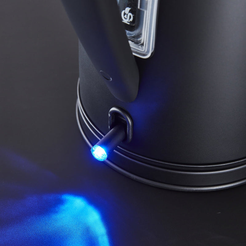 Close up photograph of Swan's 1.7 Litre Stealth Kettle switch turned on emitting a blue light 